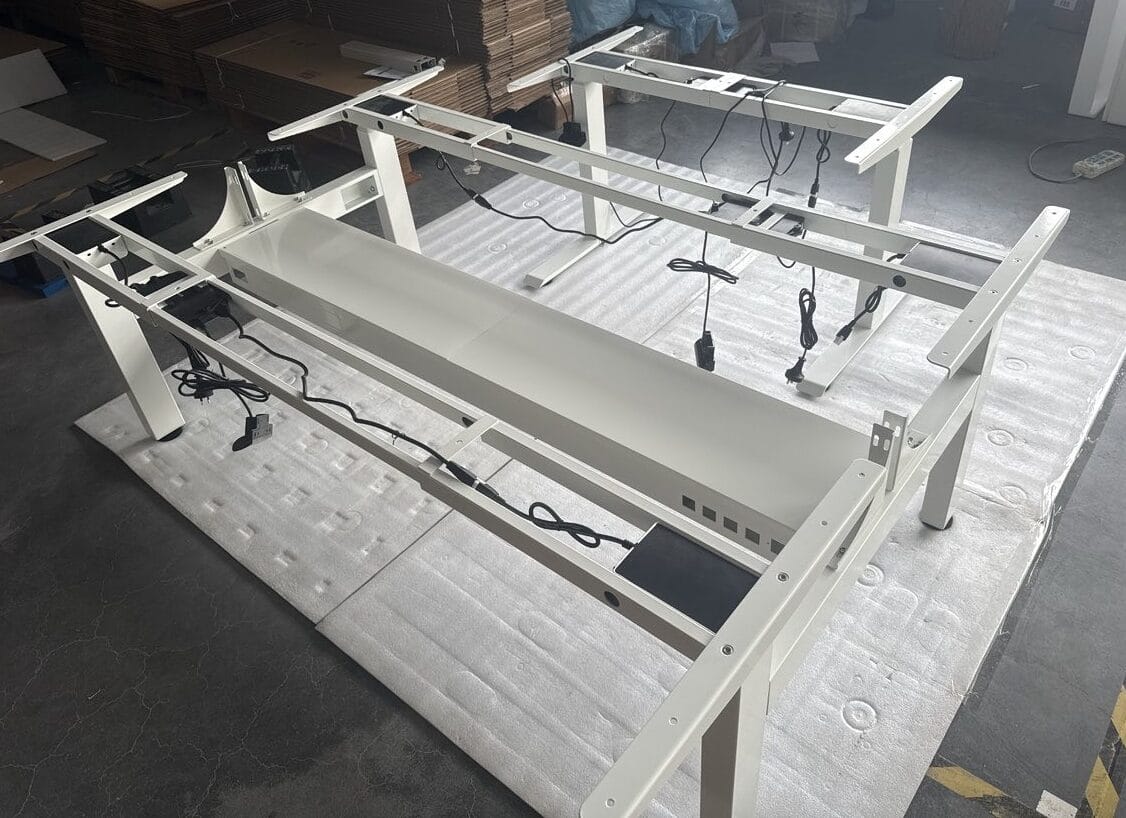 Standing desk workstations configured with cable trays, cable spines, and power components